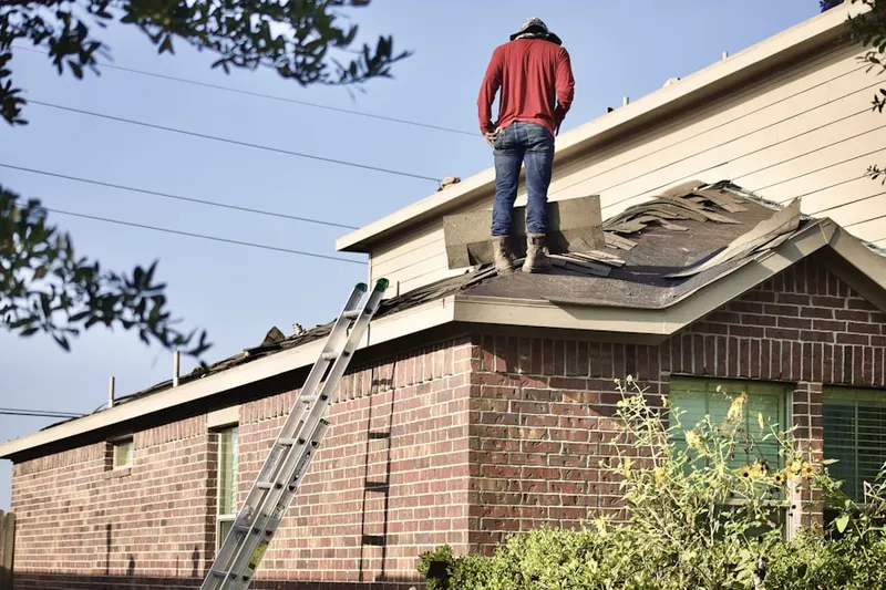 Professional roofer working on a residential roof in Eagleview